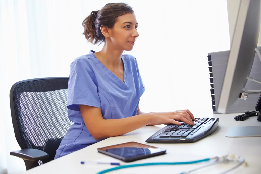 health unit coordinator working on a computer