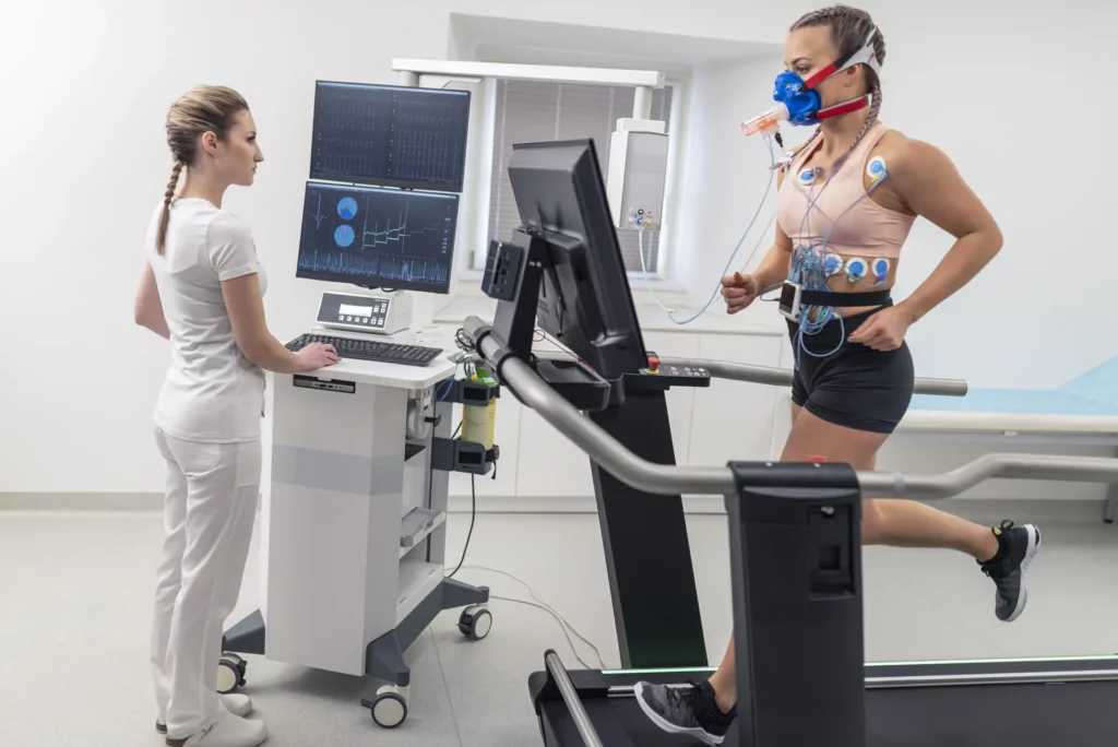 EKG tech helping out male patient on a tread mill