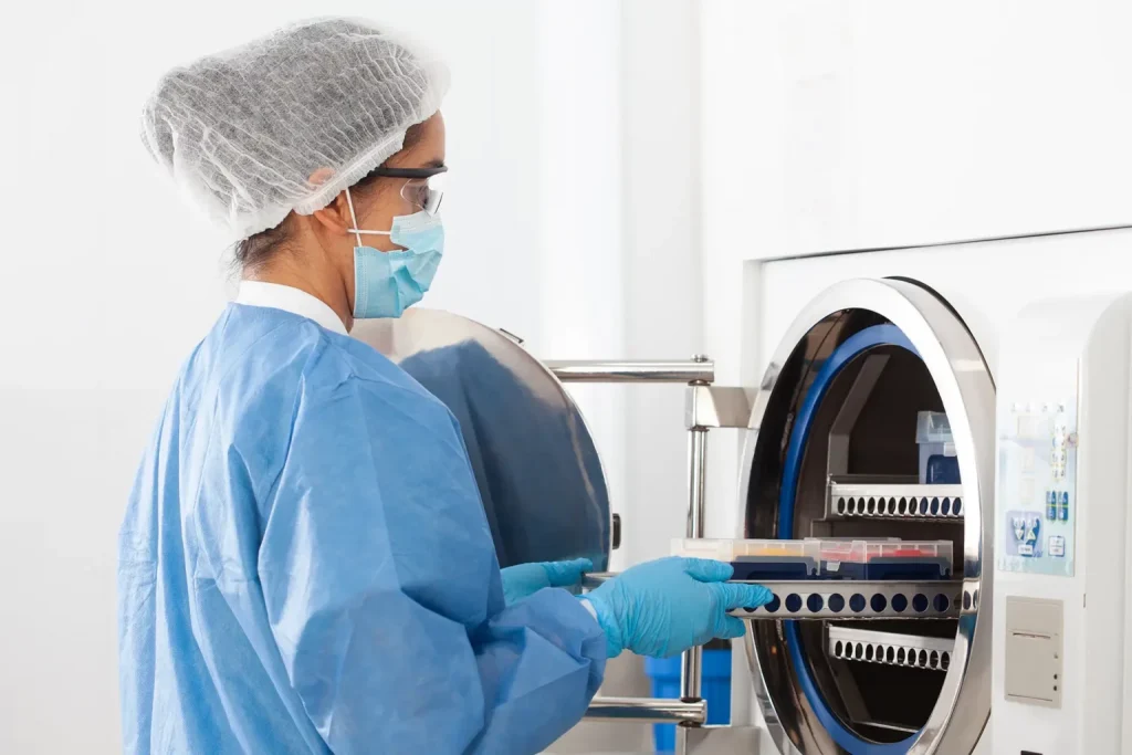 a healthcare worker sterilizing medical equipment